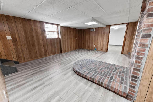 11 Hominy Hill Rd, Nancy, KY 42544 - basement featuring light wood-style floors, baseboards, wooden walls, and a paneled ceiling