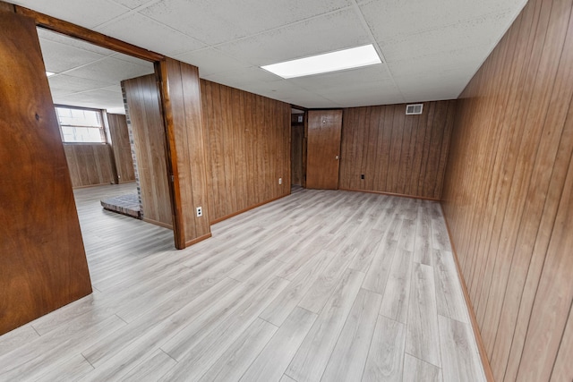 11 Hominy Hill Rd, Nancy, KY 42544 - below grade area featuring light wood-style floors, wood walls, a paneled ceiling, and visible vents