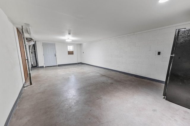 11 Hominy Hill Rd, Nancy, KY 42544 - garage featuring freestanding refrigerator, concrete block wall, and baseboards