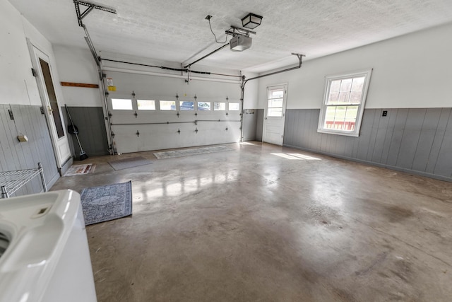 11 Hominy Hill Rd, Nancy, KY 42544 - garage with wooden walls, a garage door opener, and a wainscoted wall