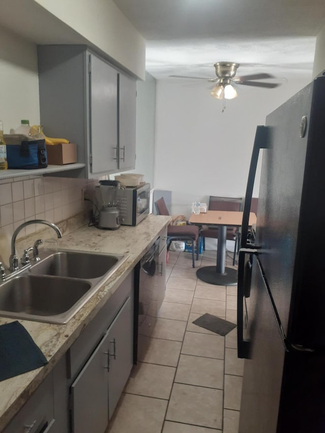 1281 Village Dr Unit C-9, Lexington, KY 40504 - kitchen featuring ceiling fan, a sink, light countertops, light tile patterned floors, and black appliances