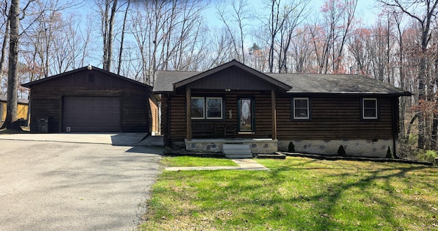 log home featuring aphalt driveway, a front lawn, a porch, a garage, and a shingled roof