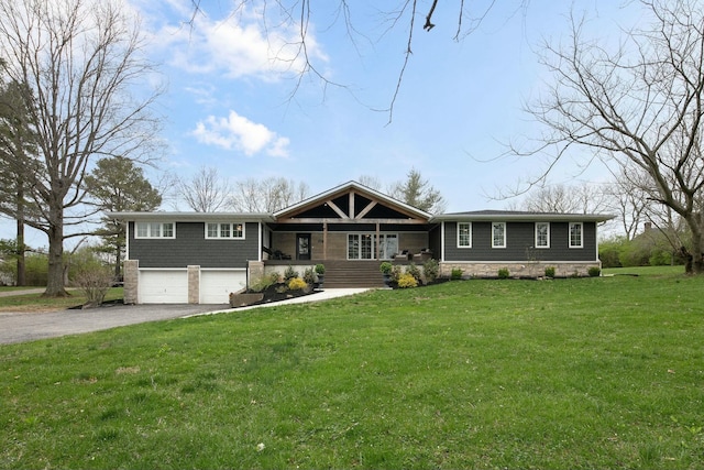 view of front facade with a front lawn, a garage, and driveway