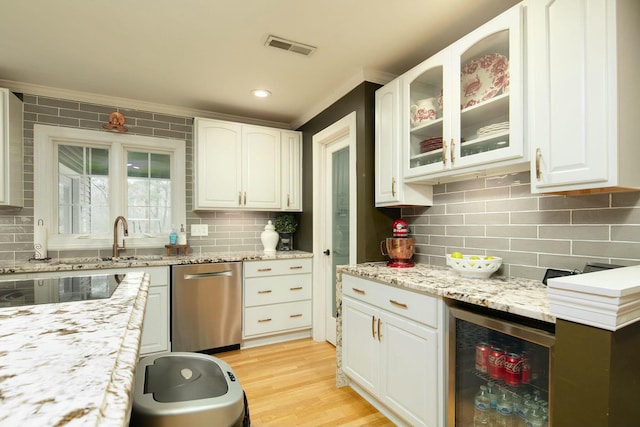 kitchen featuring wine cooler, white cabinetry, visible vents, and light wood-type flooring