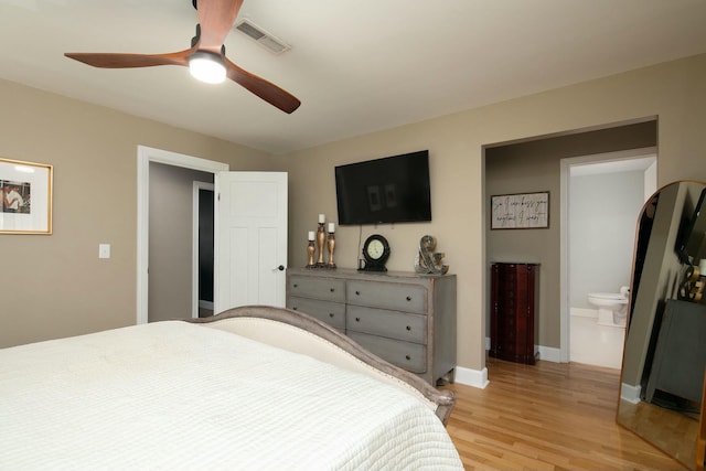 bedroom with connected bathroom, a ceiling fan, visible vents, light wood finished floors, and baseboards
