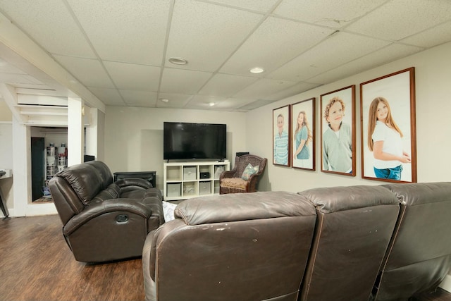 living area featuring a paneled ceiling and dark wood finished floors