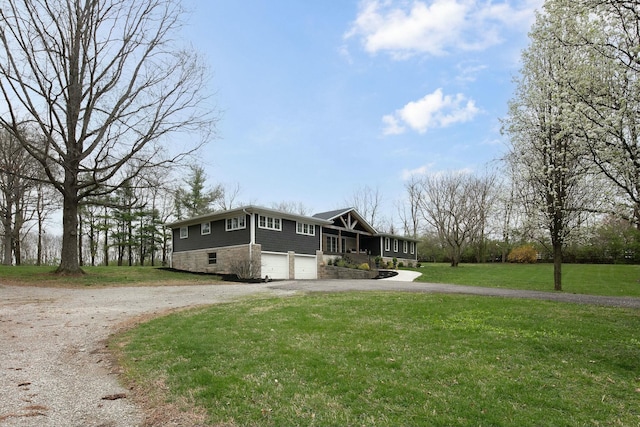 view of home's exterior featuring curved driveway, an attached garage, covered porch, and a lawn