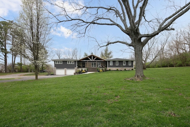 view of front of home with driveway, a garage, and a front yard