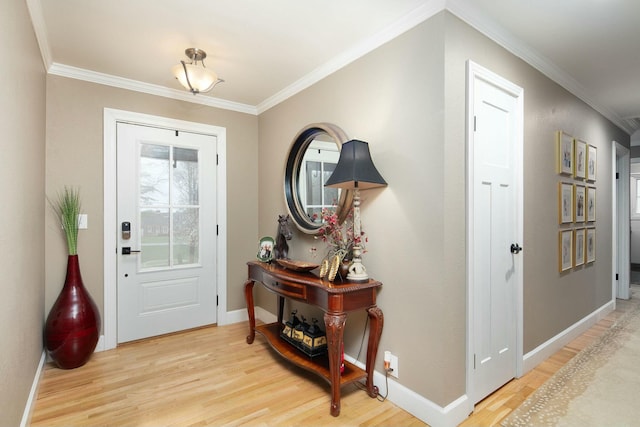 entryway with baseboards, ornamental molding, and wood finished floors