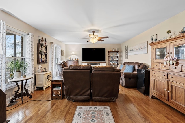 living area featuring wood finished floors and a ceiling fan