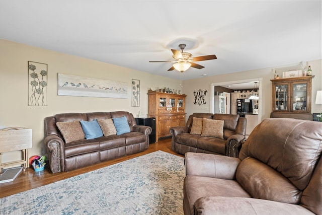 living room featuring wood finished floors and ceiling fan
