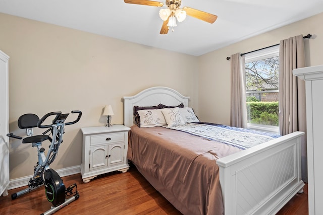 bedroom featuring ceiling fan, wood finished floors, and baseboards