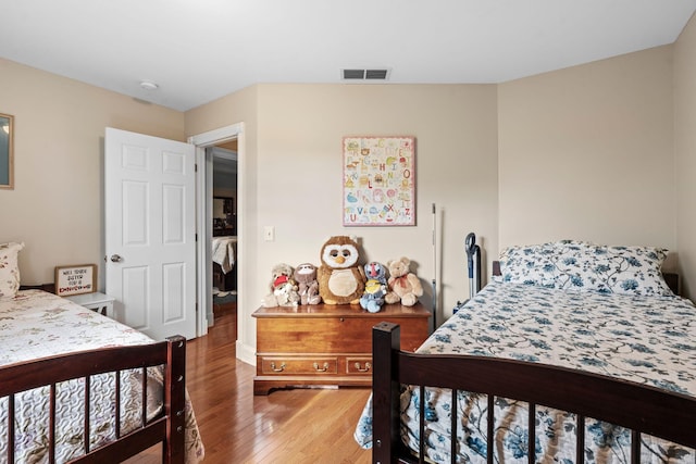 bedroom featuring visible vents and wood-type flooring