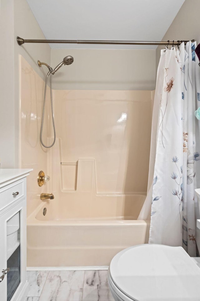 full bath featuring shower / tub combo, toilet, vanity, and marble finish floor
