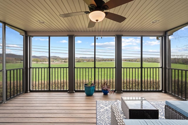 unfurnished sunroom with ceiling fan, hardwood / wood-style floors, and wood ceiling