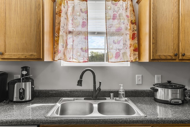 135 Country Acres Dr, Somerset, KY 42503 - kitchen featuring brown cabinetry, a sink, and dark countertops