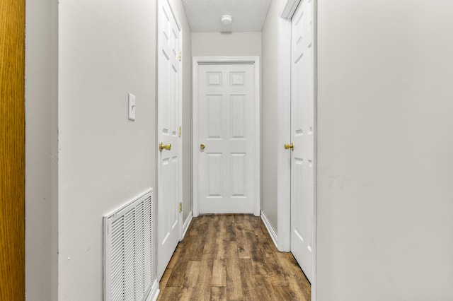 135 Country Acres Dr, Somerset, KY 42503 - hall with visible vents, a textured ceiling, baseboards, and dark wood-style floors
