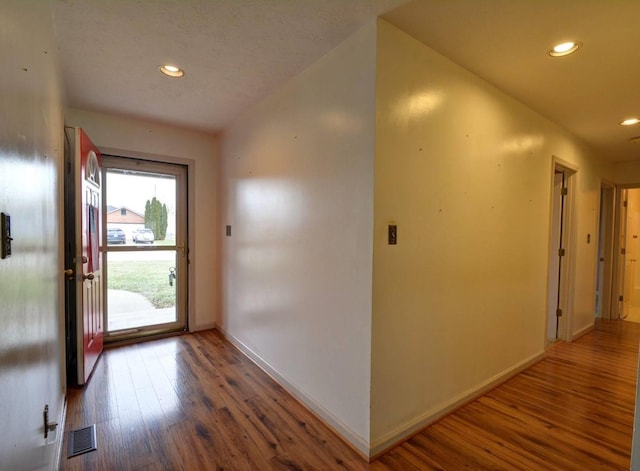 entrance foyer featuring wood finished floors, baseboards, visible vents, and recessed lighting