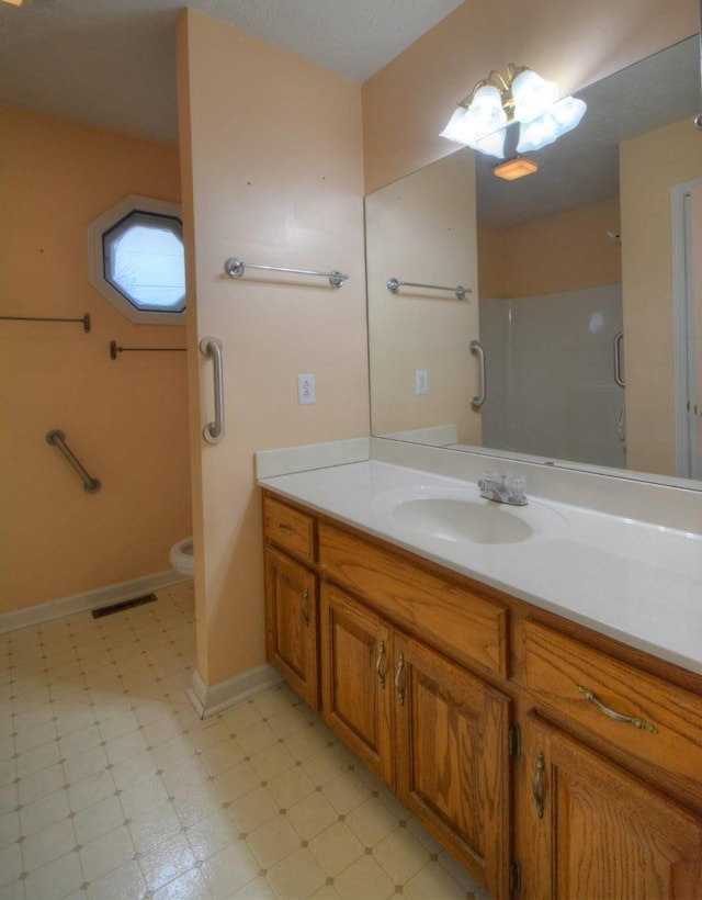 bathroom featuring vanity, tile patterned floors, an enclosed shower, toilet, and visible vents