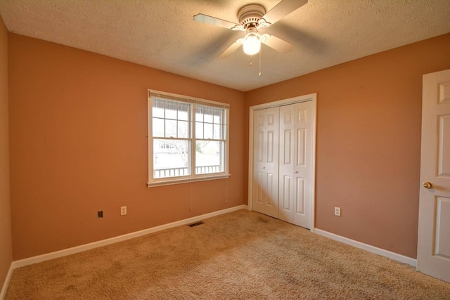 unfurnished bedroom featuring visible vents, baseboards, a closet, and carpet floors
