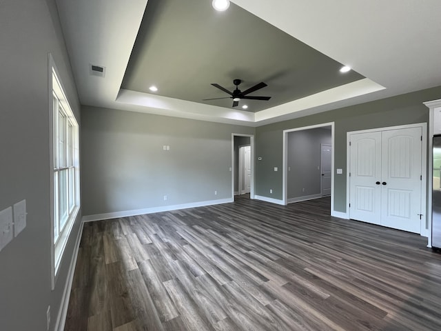 168 Bueno Xing, Georgetown, KY 40324 - unfurnished bedroom with a tray ceiling, dark wood-style floors, baseboards, recessed lighting, and a ceiling fan