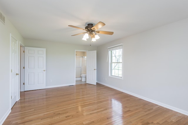 2692 Crab Orchard Rd, Lancaster, KY 40444 - unfurnished bedroom with light wood-style floors, a ceiling fan, baseboards, and connected bathroom