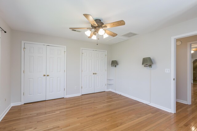 2692 Crab Orchard Rd, Lancaster, KY 40444 - unfurnished bedroom featuring light wood-style floors, two closets, visible vents, and baseboards
