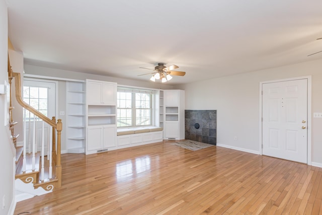 2692 Crab Orchard Rd, Lancaster, KY 40444 - unfurnished living room featuring stairway, visible vents, light wood-style floors, baseboards, and ceiling fan