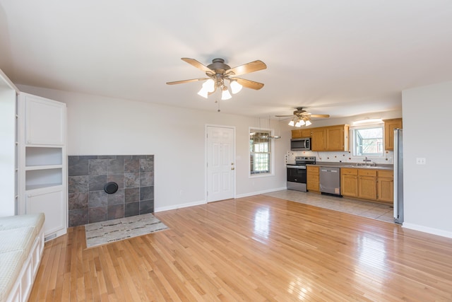 2692 Crab Orchard Rd, Lancaster, KY 40444 - unfurnished living room with ceiling fan, a healthy amount of sunlight, a sink, and light wood-type flooring