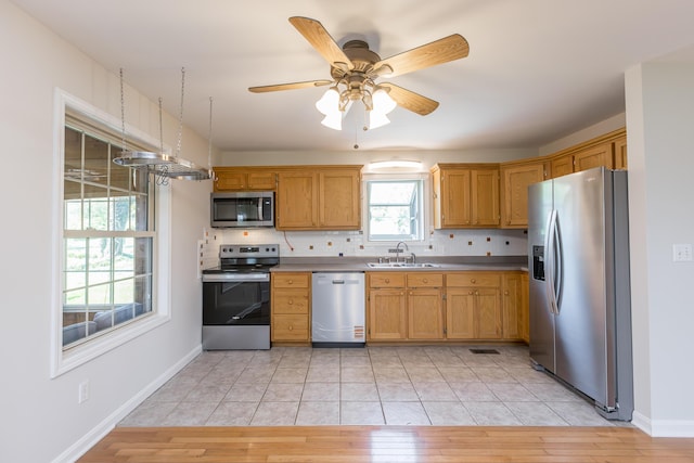 2692 Crab Orchard Rd, Lancaster, KY 40444 - kitchen featuring light wood finished floors, a sink, backsplash, and appliances with stainless steel finishes