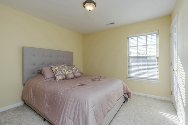 carpeted bedroom featuring visible vents and baseboards