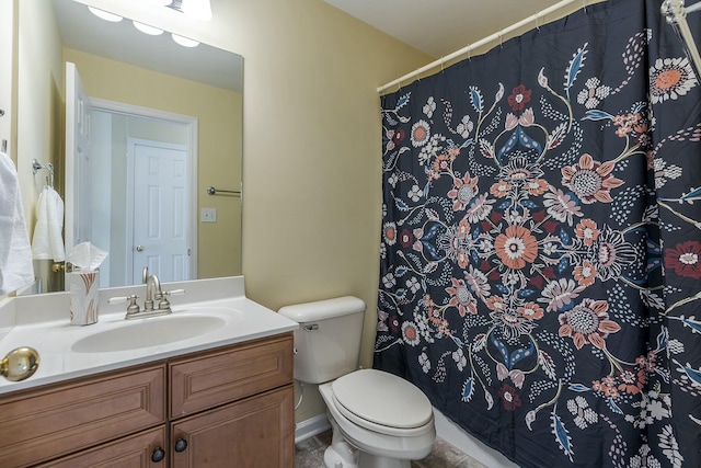 bathroom featuring toilet, vanity, and a shower with shower curtain