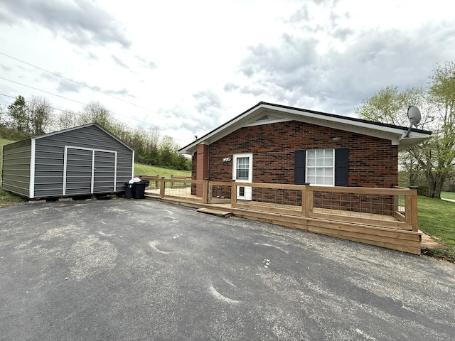 81 Central Union Rd, Albany, KY 42602 - view of property exterior with brick siding, an outdoor structure, and a deck