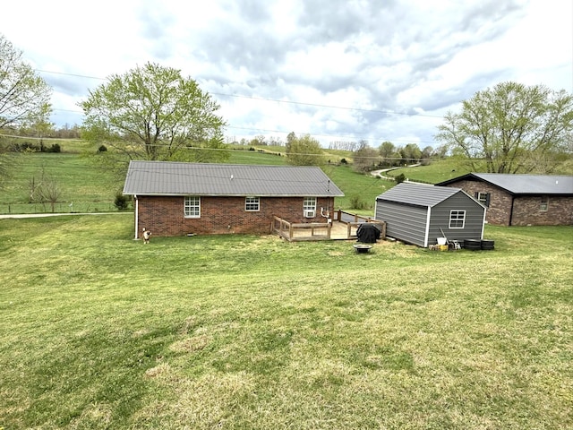81 Central Union Rd, Albany, KY 42602 - rear view of property featuring a lawn, brick siding, an outdoor structure, and a deck