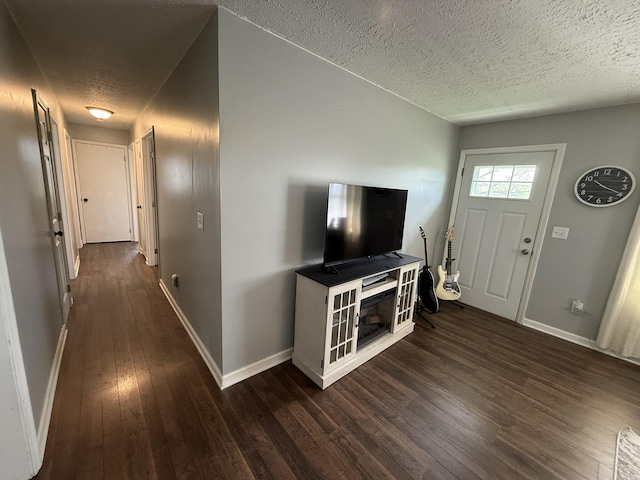 81 Central Union Rd, Albany, KY 42602 - unfurnished living room featuring dark wood-style floors, baseboards, and a textured ceiling