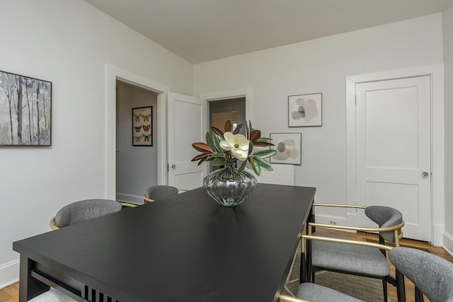 dining area with wood finished floors and baseboards