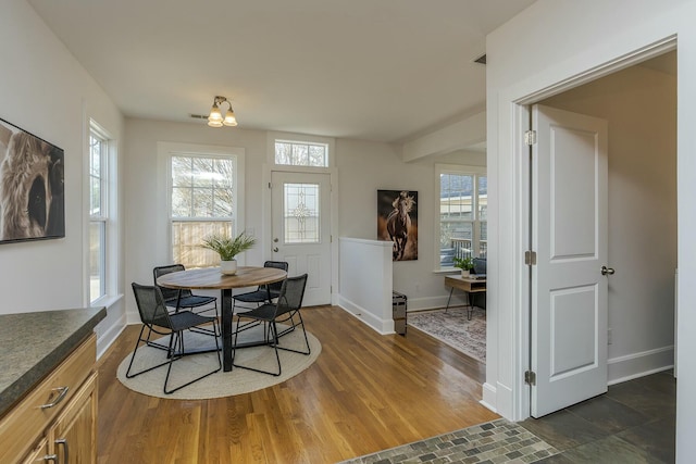 dining room with baseboards and wood finished floors