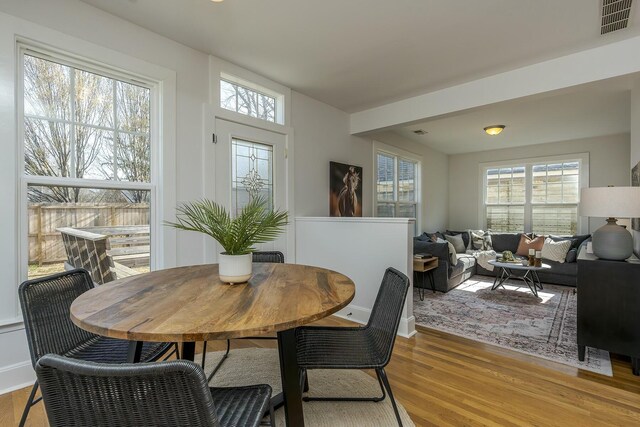 dining space featuring visible vents and light wood-style flooring