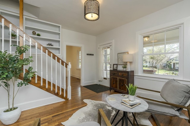 interior space with stairs, baseboards, and dark wood finished floors