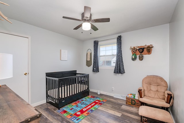 9 Blanche Ave, Williamstown, KY 41097 - bedroom featuring baseboards, visible vents, a nursery area, ceiling fan, and wood finished floors