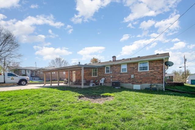 9 Blanche Ave, Williamstown, KY 41097 - rear view of property featuring concrete driveway, cooling unit, a patio area, brick siding, and a lawn