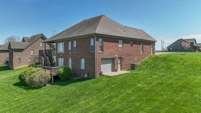 614 Apricot Dr, Richmond, KY 40475 - back of property with central AC unit, a lawn, a garage, stairs, and brick siding