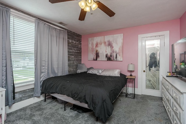 264 Houston Ave, Paris, KY 40361 - bedroom with visible vents, a ceiling fan, an accent wall, and wood walls