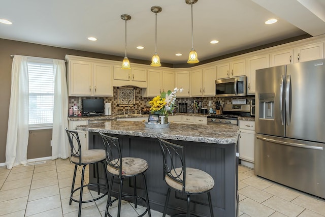 264 Houston Ave, Paris, KY 40361 - kitchen with appliances with stainless steel finishes, decorative backsplash, light tile patterned floors, and a center island