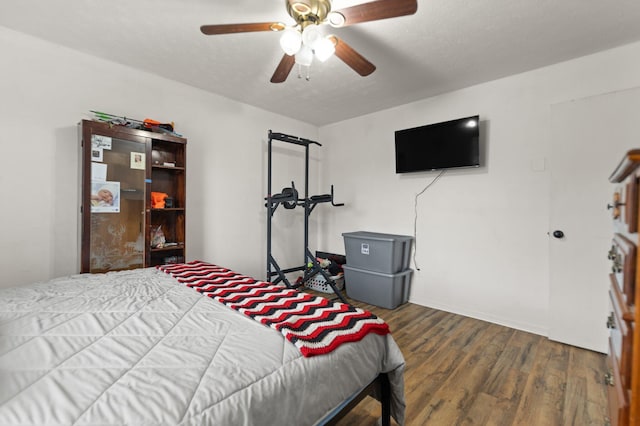 bedroom featuring a ceiling fan and wood finished floors