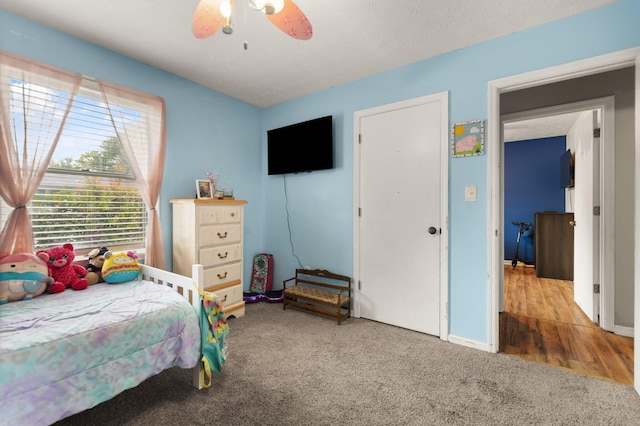 carpeted bedroom featuring ceiling fan and baseboards