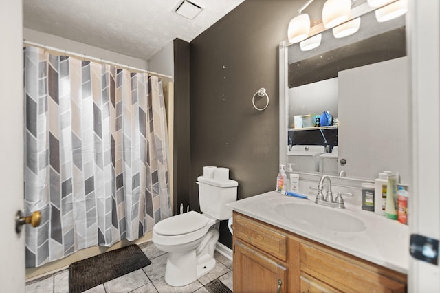 bathroom with vanity, visible vents, toilet, tile patterned floors, and washing machine and dryer