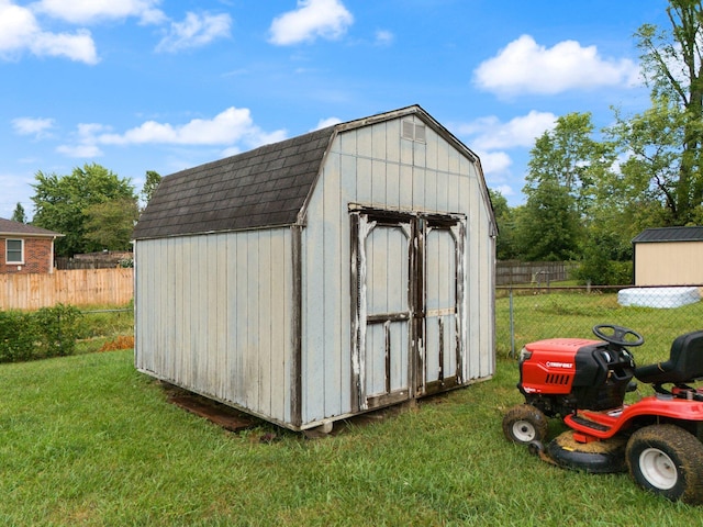 view of shed featuring fence