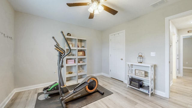 exercise room with a ceiling fan, baseboards, visible vents, and wood finished floors