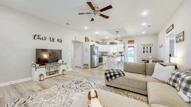 living area featuring recessed lighting, a ceiling fan, light wood-style flooring, and visible vents